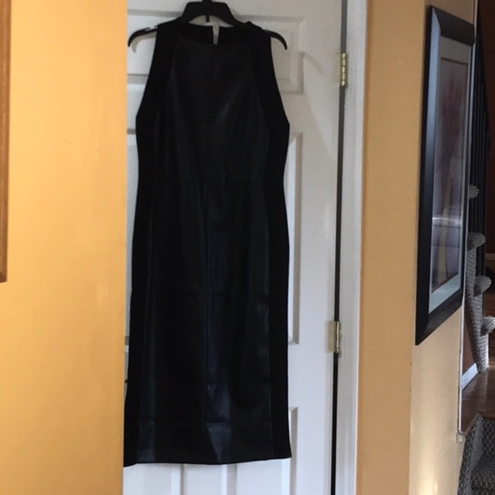 Midi length dress. Faux leather front and back panels. Knit side panels